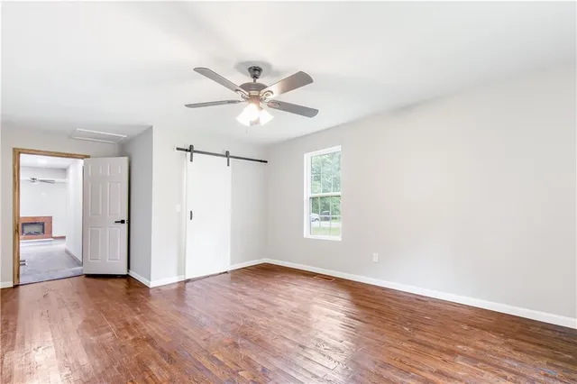 a view of a livingroom with a ceiling fan and window