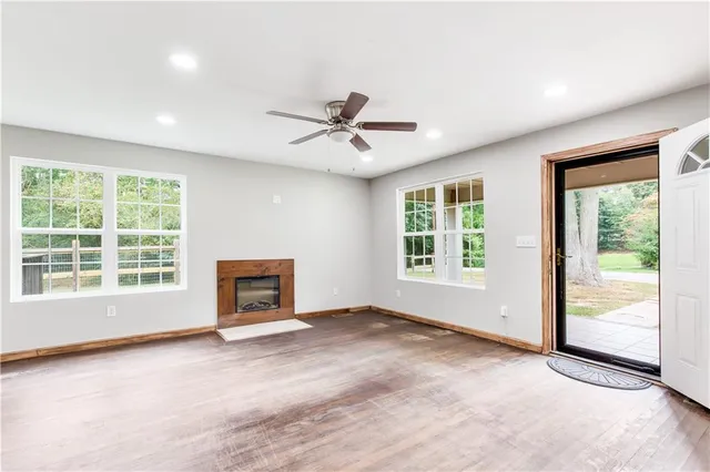 a view of an empty room with a ceiling fan
