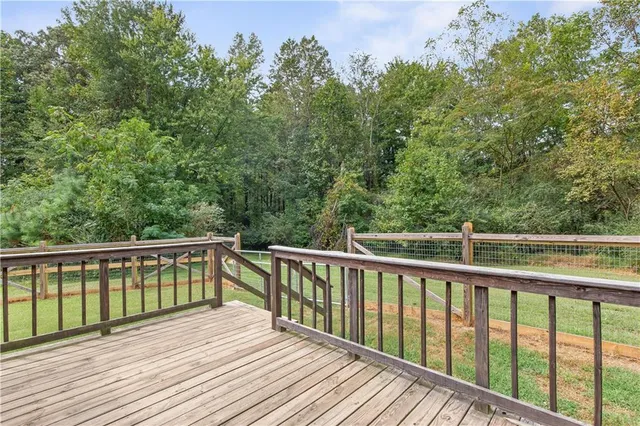 a balcony with wooden floor and fence