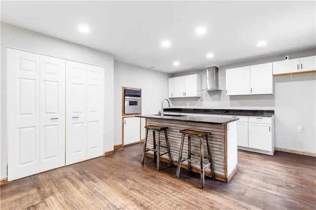 a kitchen with granite countertop a sink and a stove top oven