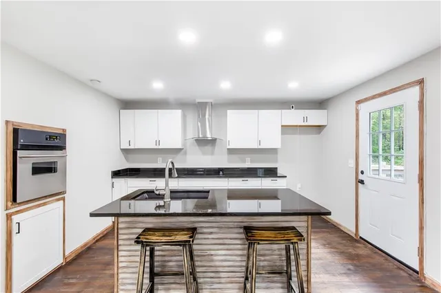 a white house that has a tree in front of it