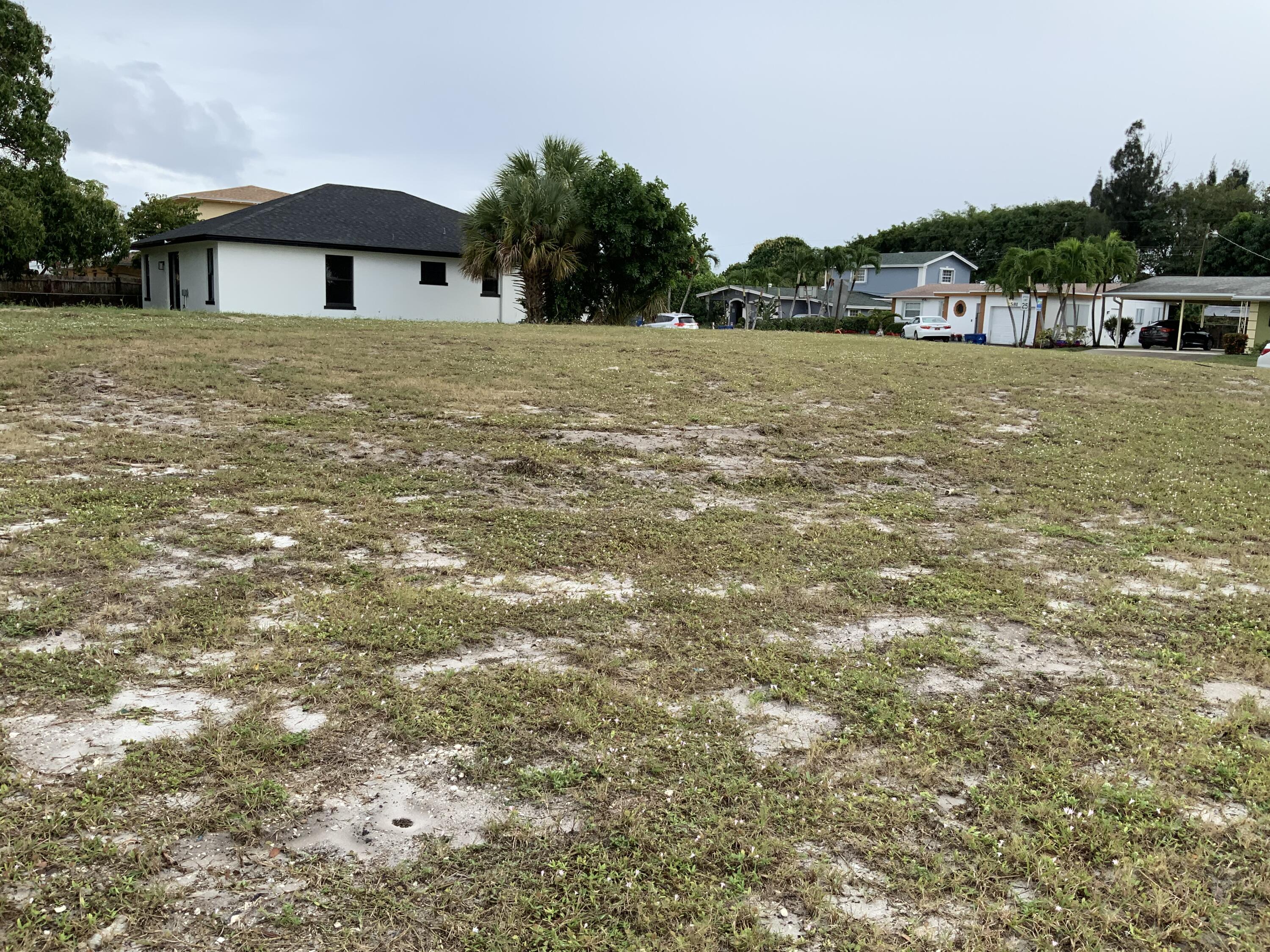 a front view of a house with a yard and mountain view