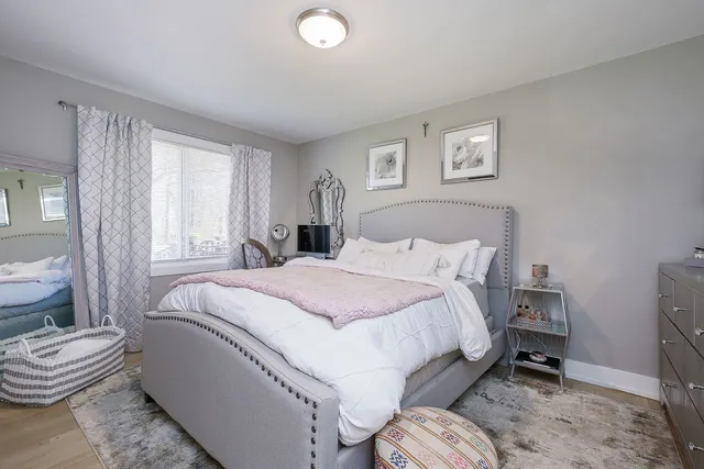 a bedroom with a bed and a chair