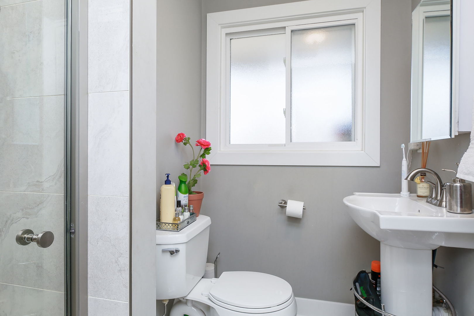 3309 York Road Oak Brook, IL 60523 - Photo 14 of 18 a bathroom with a sink a toilet and a mirror