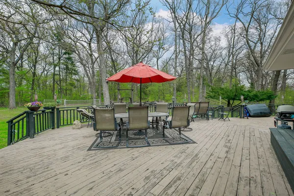 a view of a dinning table and chairs on the deck