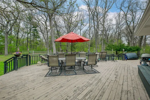 a view of a dinning table and chairs on the deck