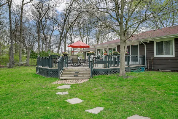 a view of a house with a yard and sitting area