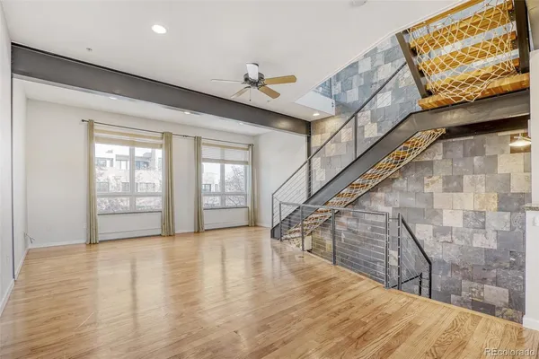a view of a hallway with wooden floor and staircase