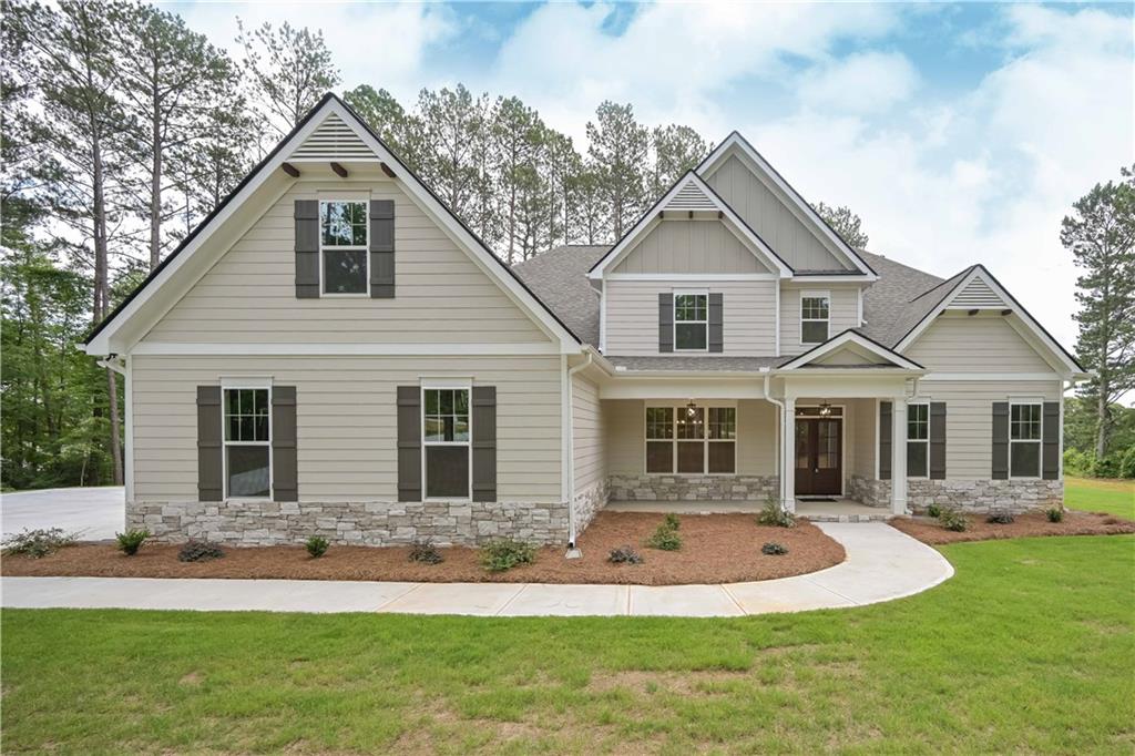 a front view of a house with a yard and trees