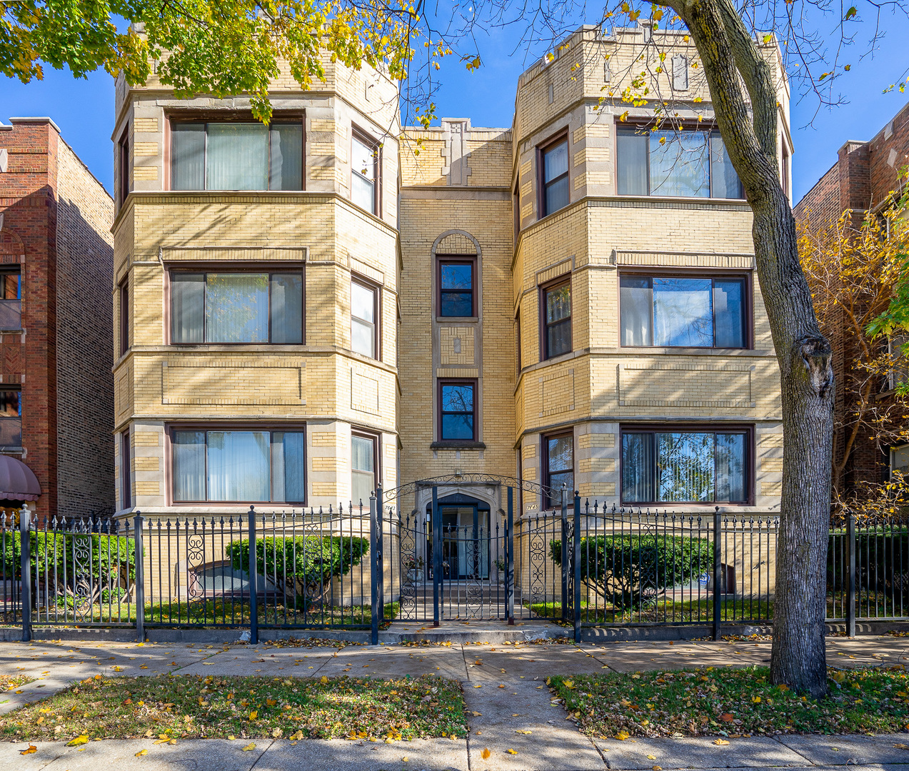 7645 South Yates Boulevard, Unit 1S Chicago, IL 60649 - Photo 1 of 23 a front view of a residential apartment building with a yard