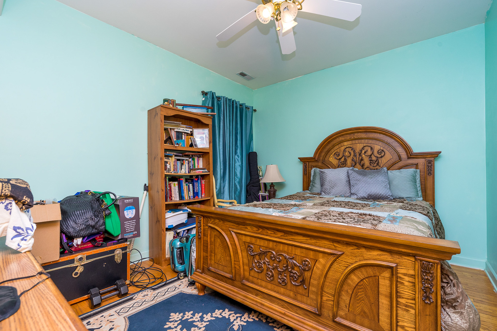 7645 South Yates Boulevard, Unit 1S Chicago, IL 60649 - Photo 14 of 23 a bedroom with a bed and a chandelier