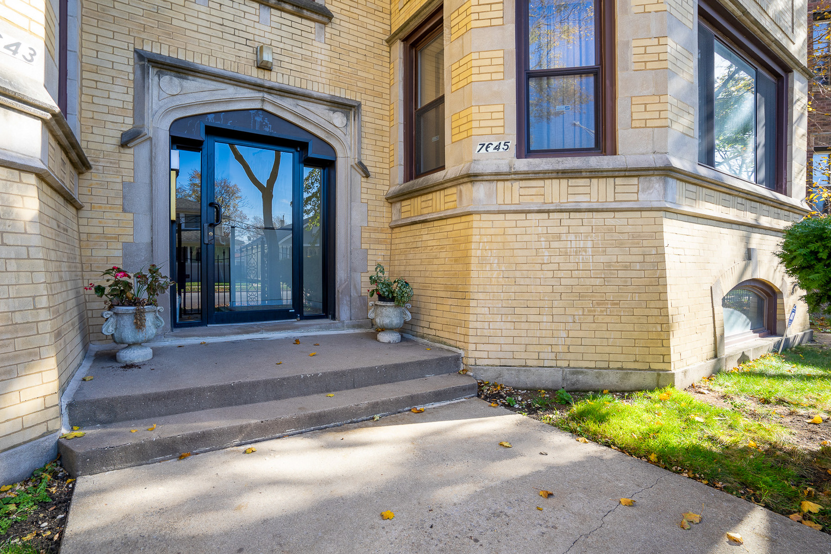 7645 South Yates Boulevard, Unit 1S Chicago, IL 60649 - Photo 21 of 23 a front view of a house with a garden
