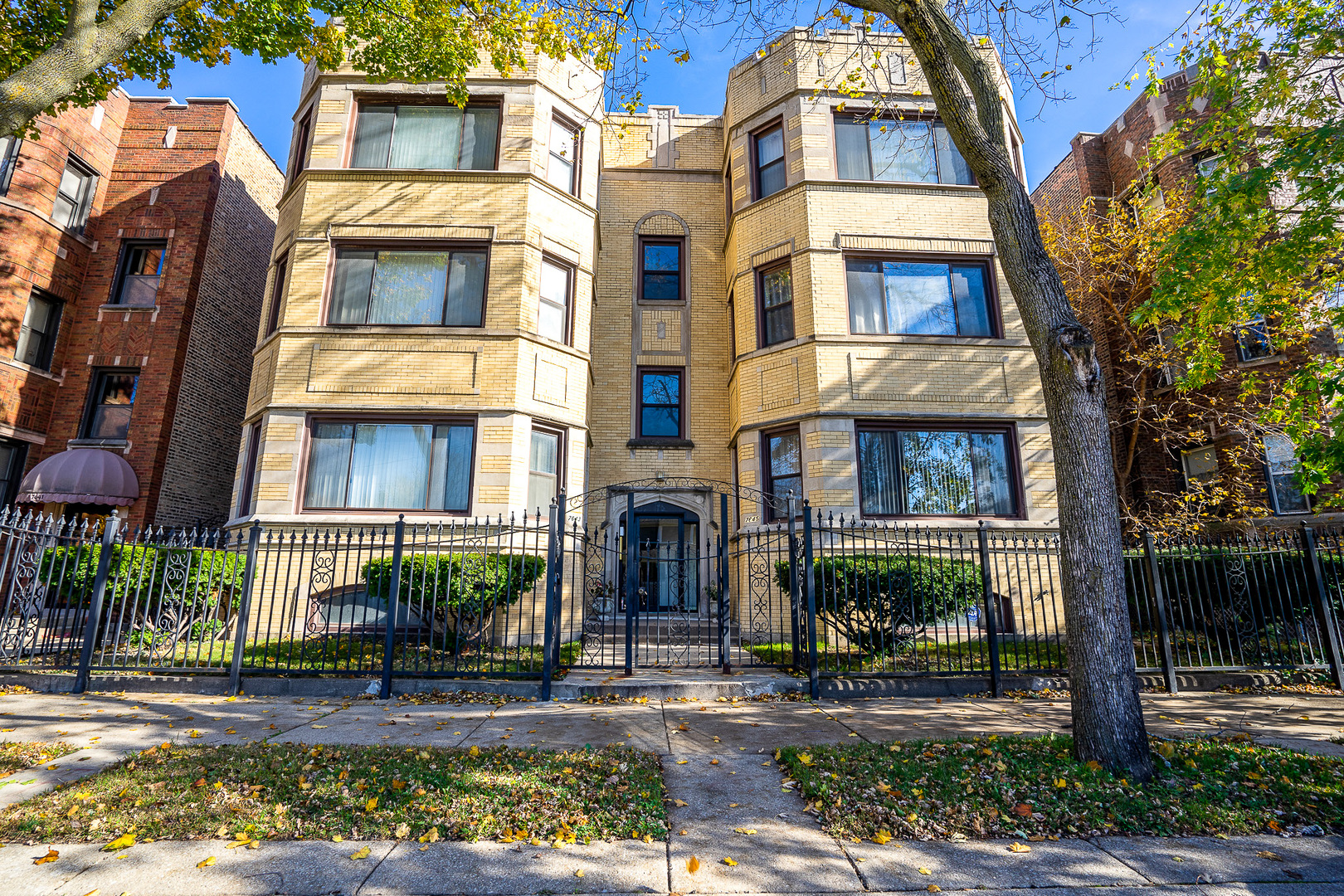 7645 South Yates Boulevard, Unit 1S Chicago, IL 60649 - Photo 23 of 23 a front view of a residential apartment building with a yard