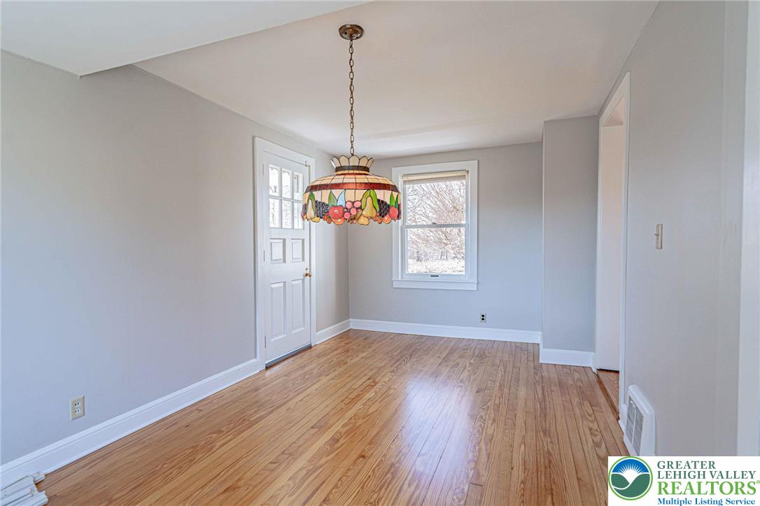 6245 Vera Cruz Road Emmaus, PA 18049 - Photo 13 of 72 a view of an empty room with window and wooden floor
