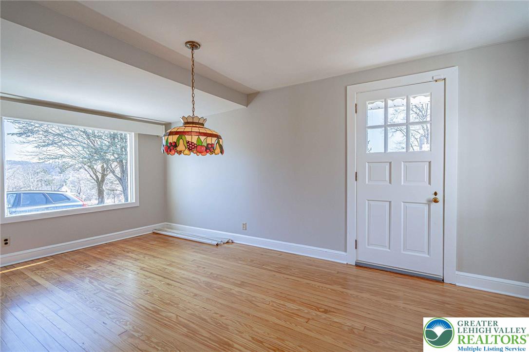 6245 Vera Cruz Road Emmaus, PA 18049 - Photo 15 of 72 a view of an empty room with wooden floor and a window