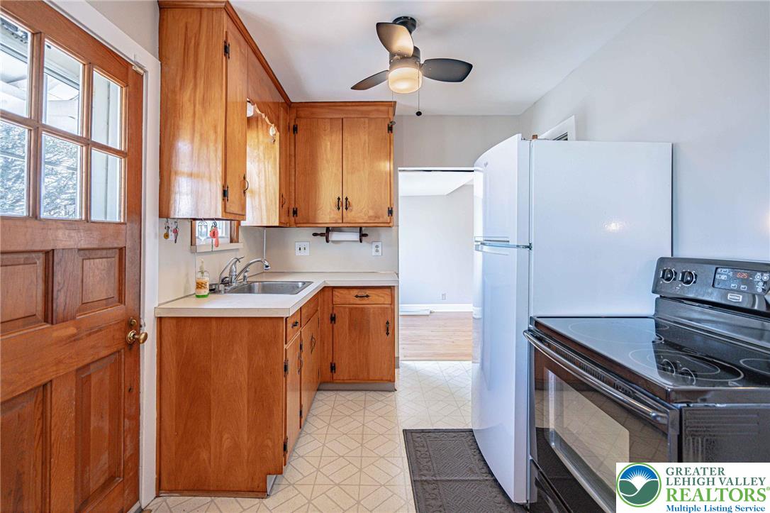 6245 Vera Cruz Road Emmaus, PA 18049 - Photo 22 of 72 a kitchen with stainless steel appliances granite countertop a refrigerator a sink dishwasher a stove and white countertops with wooden floor