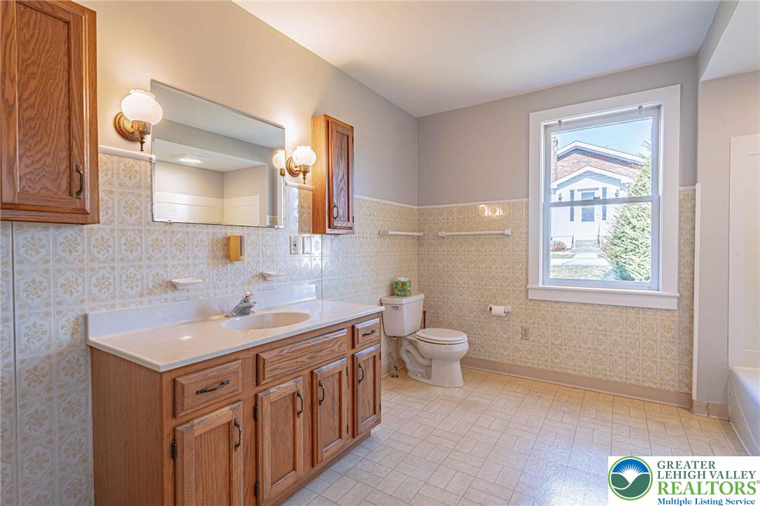 6245 Vera Cruz Road Emmaus, PA 18049 - Photo 31 of 72 a bathroom with a sink a toilet and a window