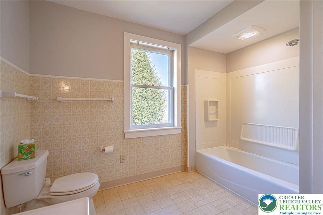 6245 Vera Cruz Road Emmaus, PA 18049 - Photo 32 of 72 a bathroom with a granite countertop toilet a sink and bathtub