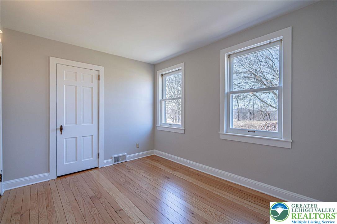 6245 Vera Cruz Road Emmaus, PA 18049 - Photo 40 of 72 a view of an empty room with wooden floor and a window