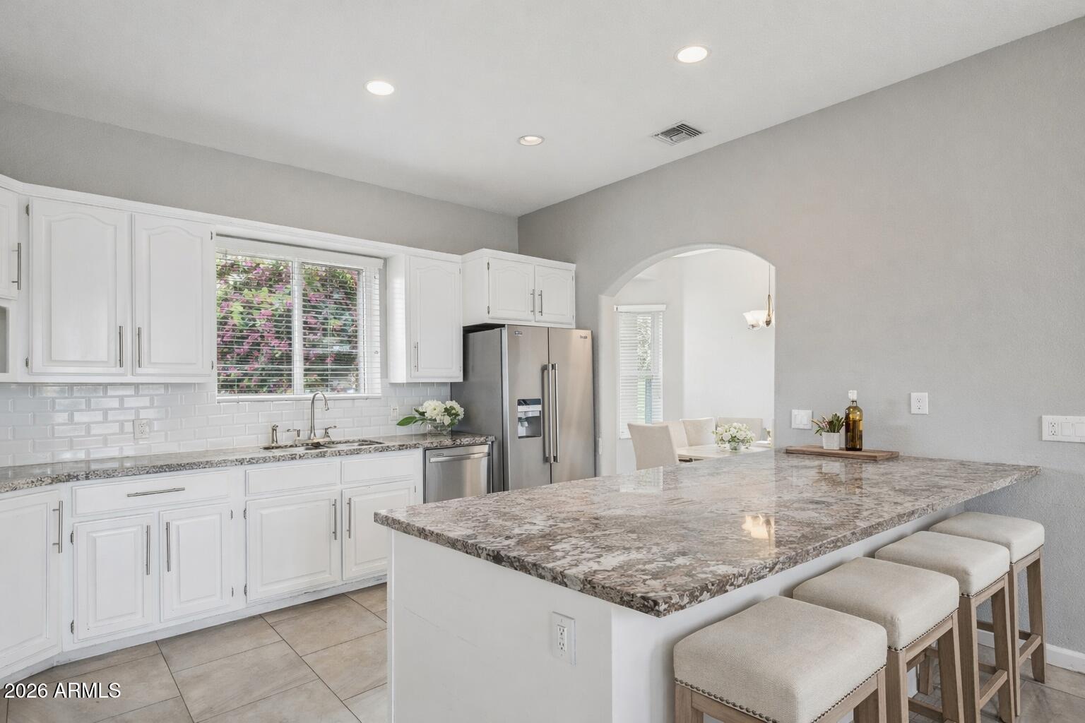 702 West Why Worry Lane Phoenix, AZ 85021 - Photo 9 of 53 a kitchen with stainless steel appliances granite countertop a sink and cabinets