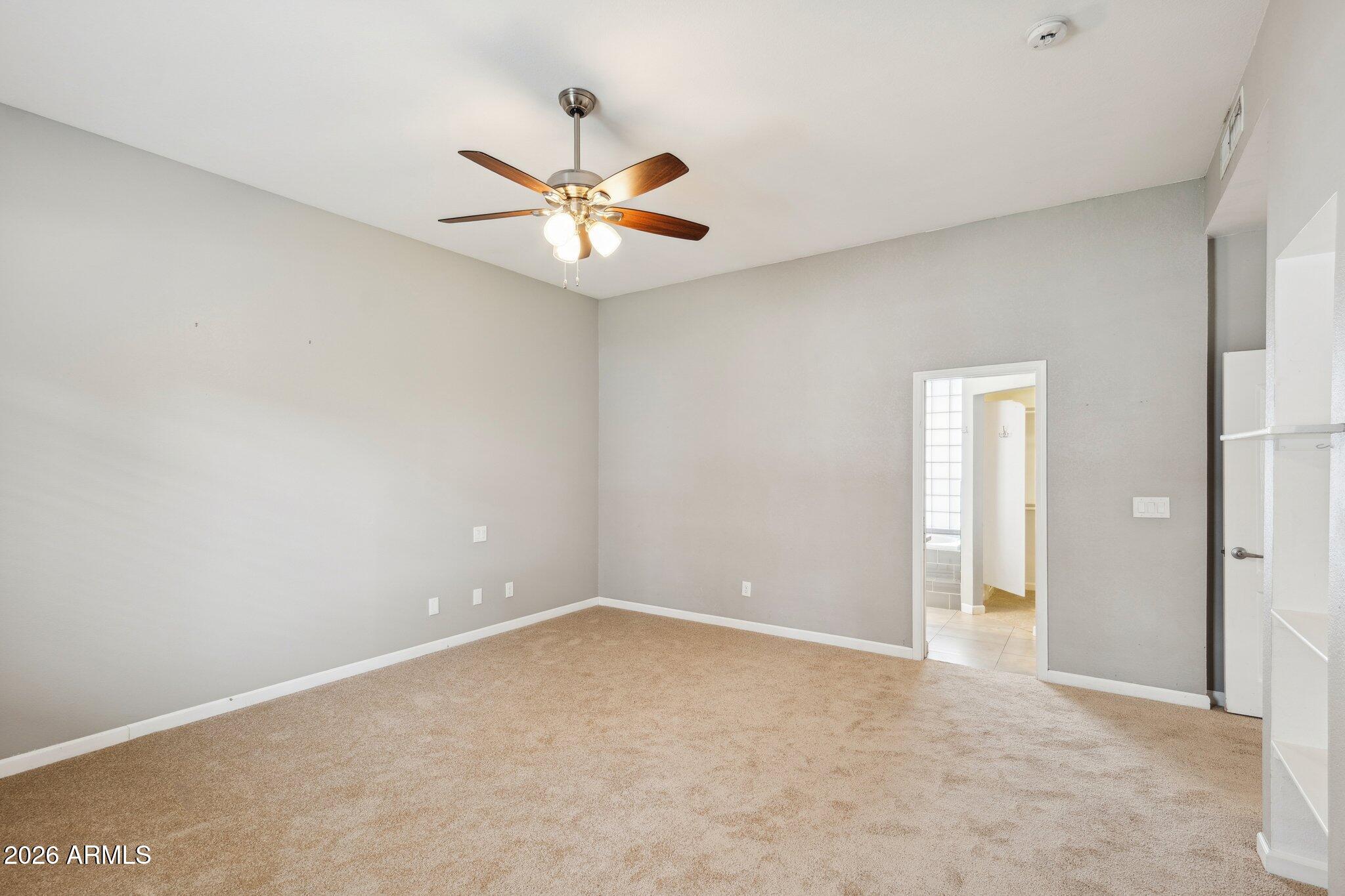 702 West Why Worry Lane Phoenix, AZ 85021 - Photo 13 of 34 an empty room with windows and fan
