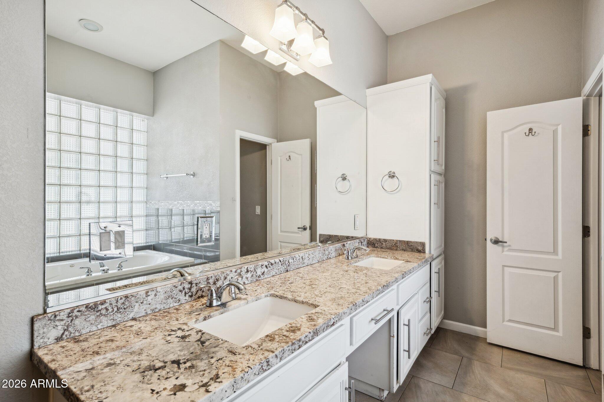702 West Why Worry Lane Phoenix, AZ 85021 - Photo 14 of 34 a bathroom with a granite countertop sink and a mirror