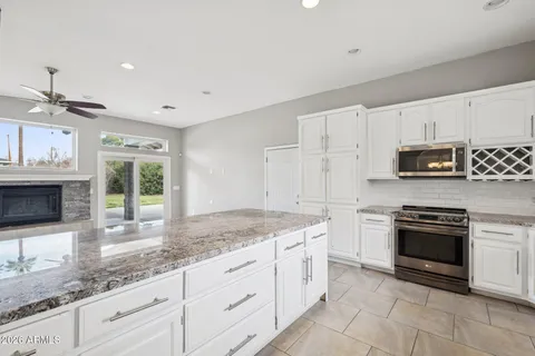 a kitchen with stainless steel appliances granite countertop a sink and cabinets