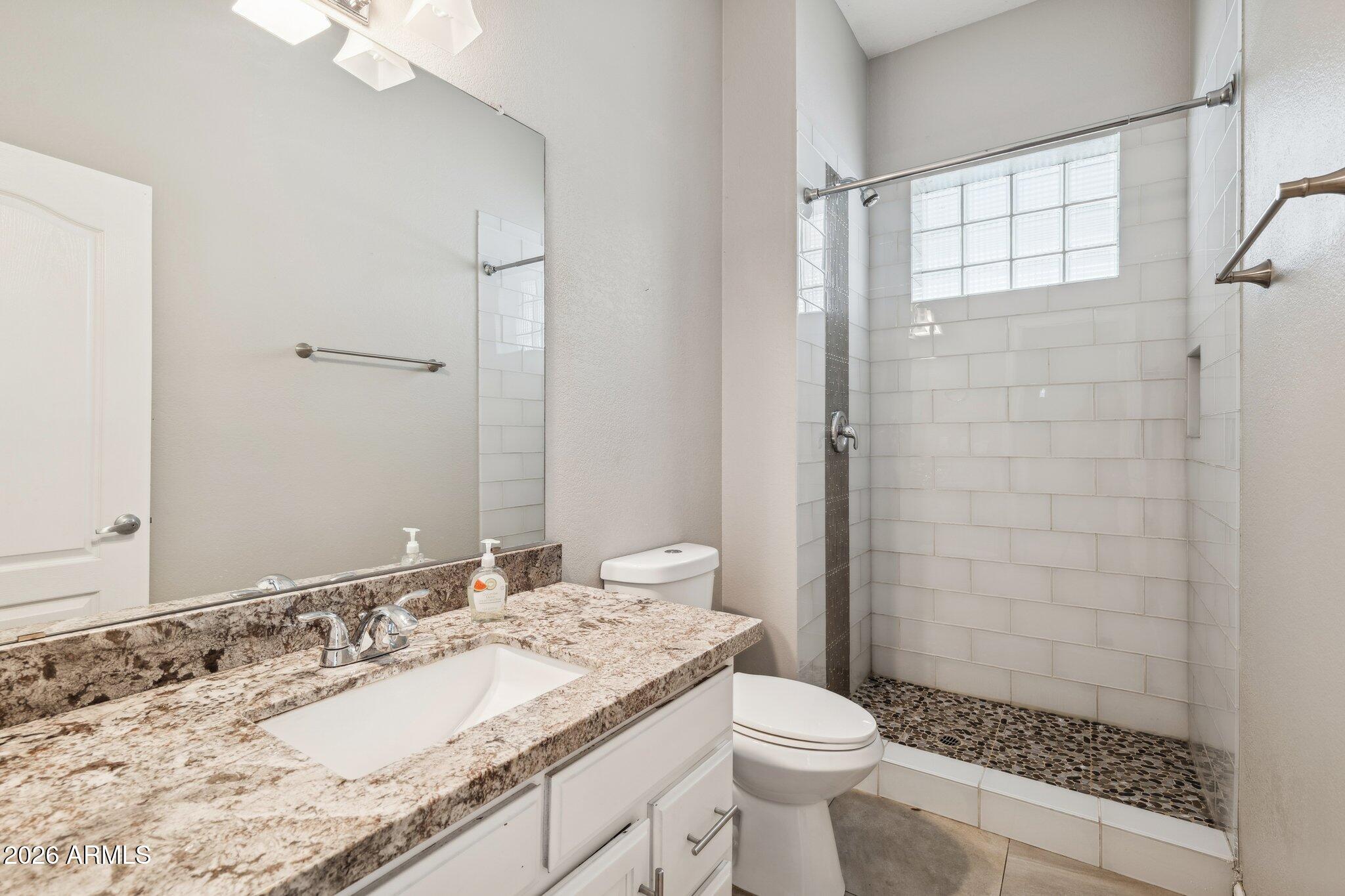 702 West Why Worry Lane Phoenix, AZ 85021 - Photo 15 of 53 a bathroom with a granite countertop sink toilet and shower