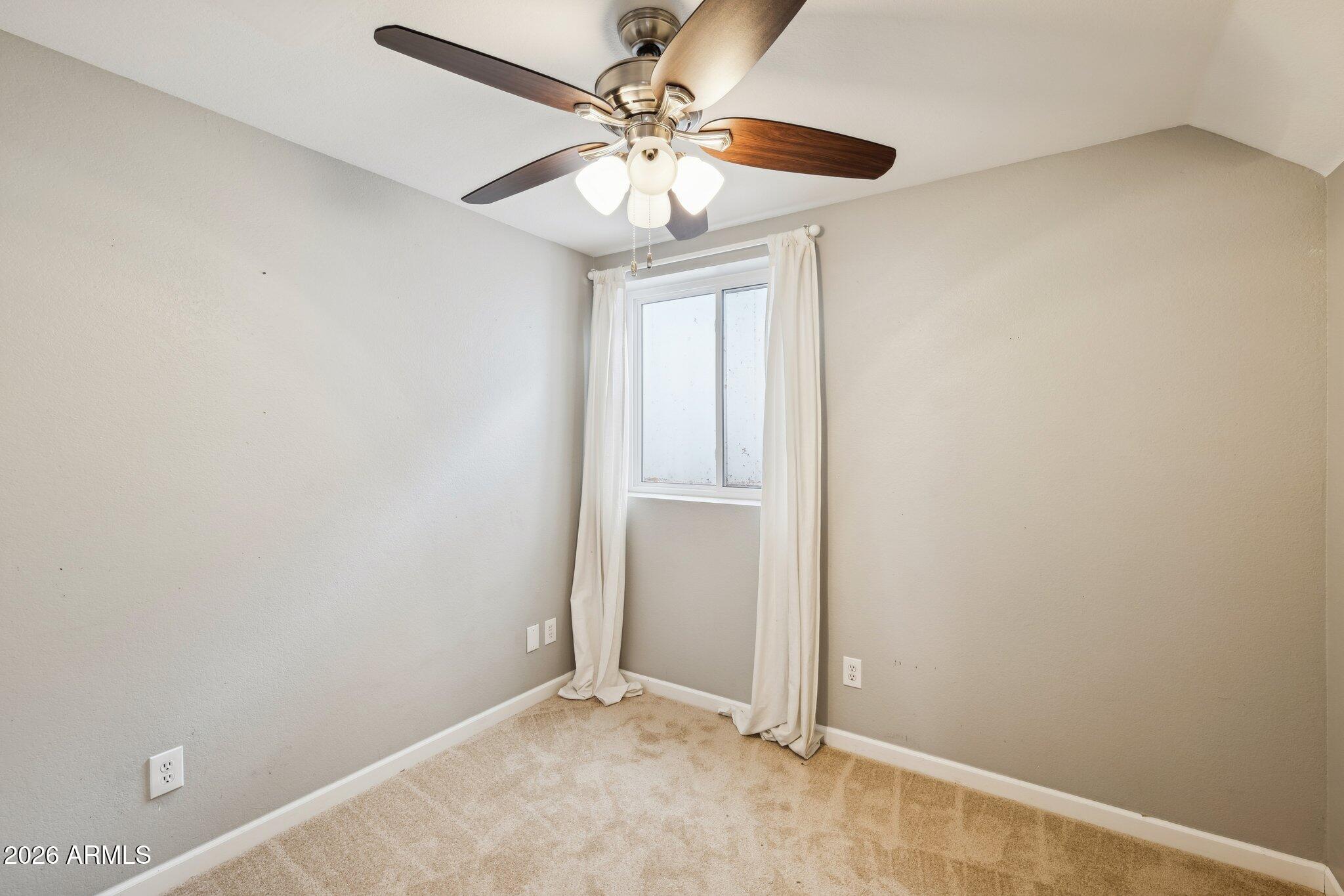 702 West Why Worry Lane Phoenix, AZ 85021 - Photo 20 of 34 an empty room with windows and fan