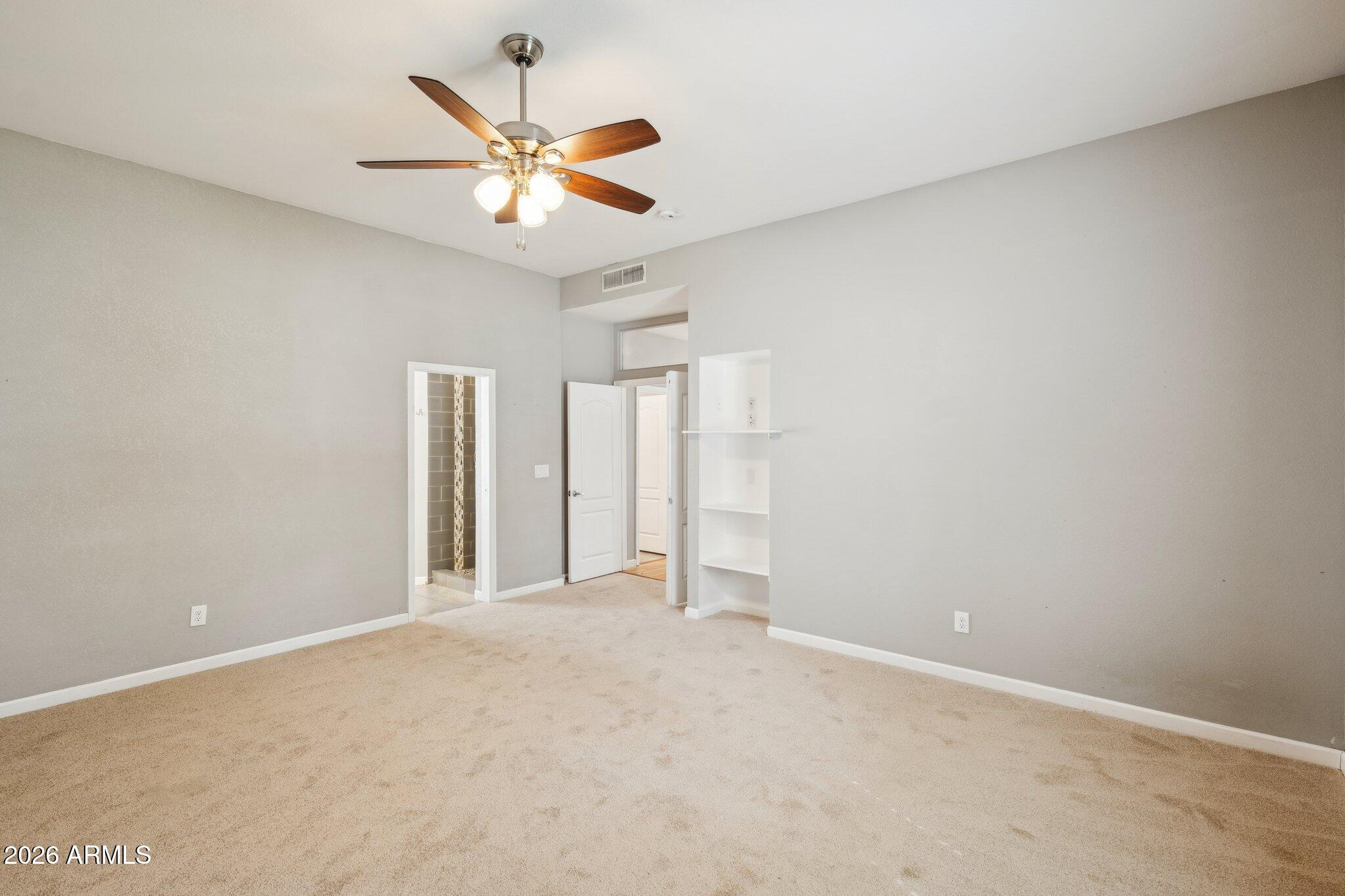 702 West Why Worry Lane Phoenix, AZ 85021 - Photo 17 of 53 an empty room with closet and ceiling fan