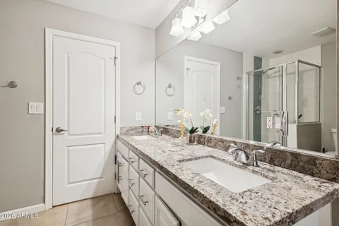 an empty room with closet and a chandelier fan