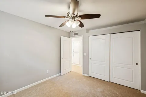 a bathroom with a granite countertop double vanity sink and a mirror