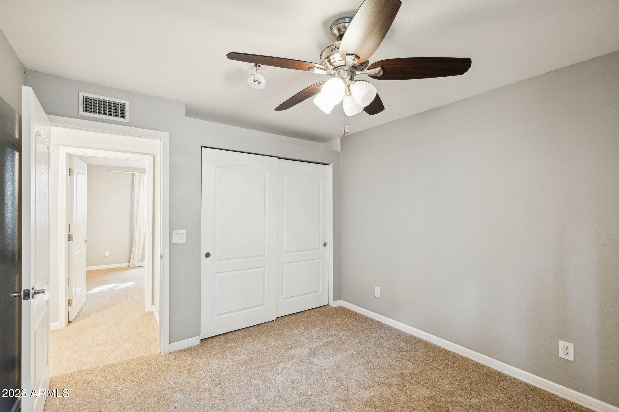 702 West Why Worry Lane Phoenix, AZ 85021 - Photo 38 of 53 an empty room with windows and fan