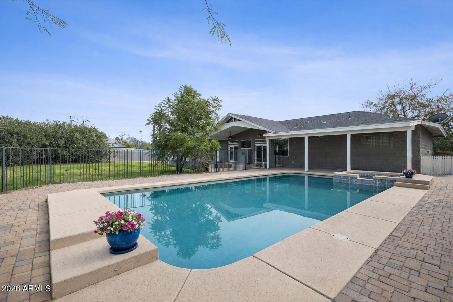 702 West Why Worry Lane Phoenix, AZ 85021 - Photo 40 of 53 a front view of a house with swimming pool garden and patio