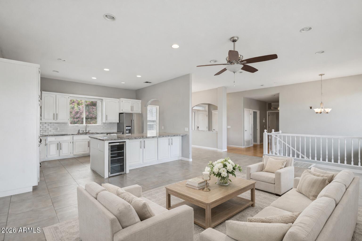 702 West Why Worry Lane Phoenix, AZ 85021 - Photo 5 of 34 a living room with furniture kitchen view and a chandelier