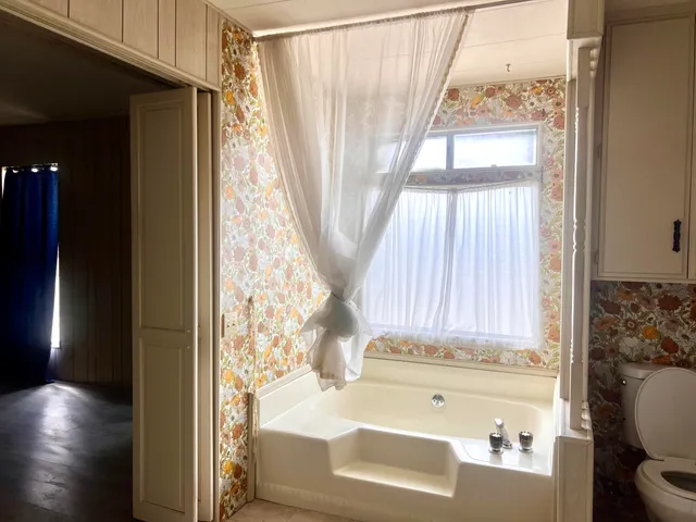 a bathroom with a bathtub and a window