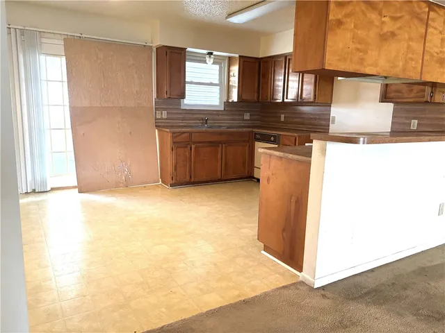 a kitchen with stainless steel appliances granite countertop a sink and a stove