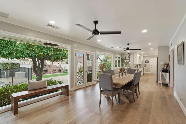 a dining room with furniture window and wooden floor