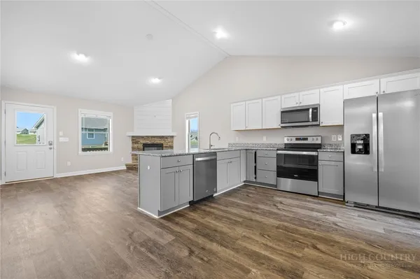 a kitchen with a refrigerator sink and cabinets