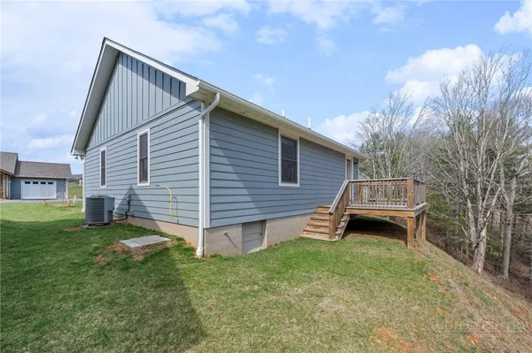 a backyard of a house with table and chairs
