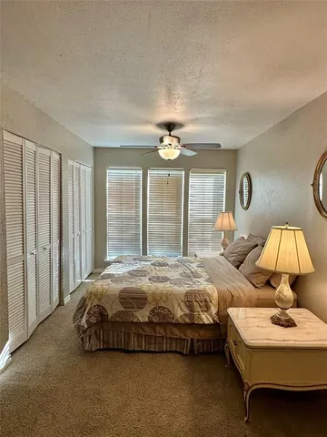 a bedroom with bed and a window