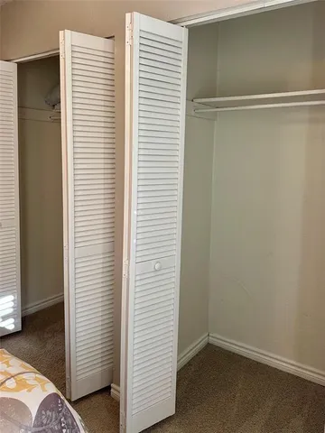 a view of walk in closet with clothes