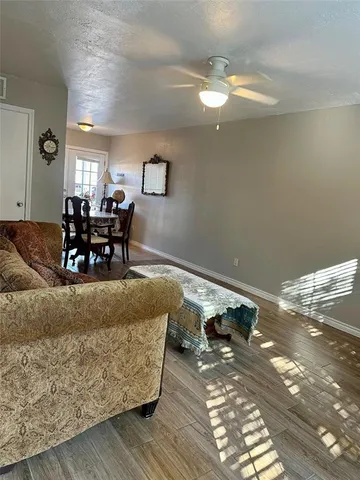 a living room with furniture and a dining table