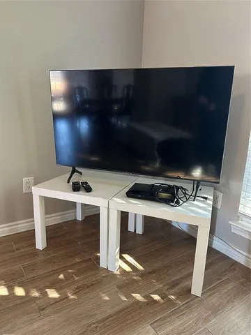 a view of a room with wooden floor