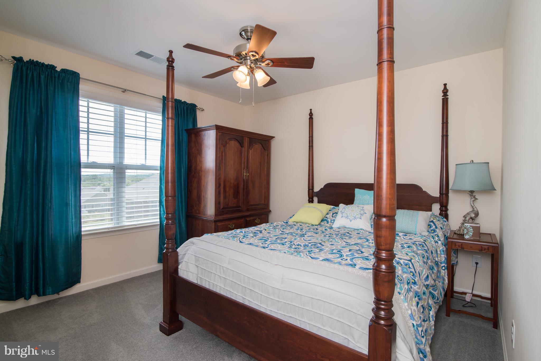 41 Houston Road Inwood, WV 25428 - Photo 21 of 30 a bedroom with a bed chandelier and a window