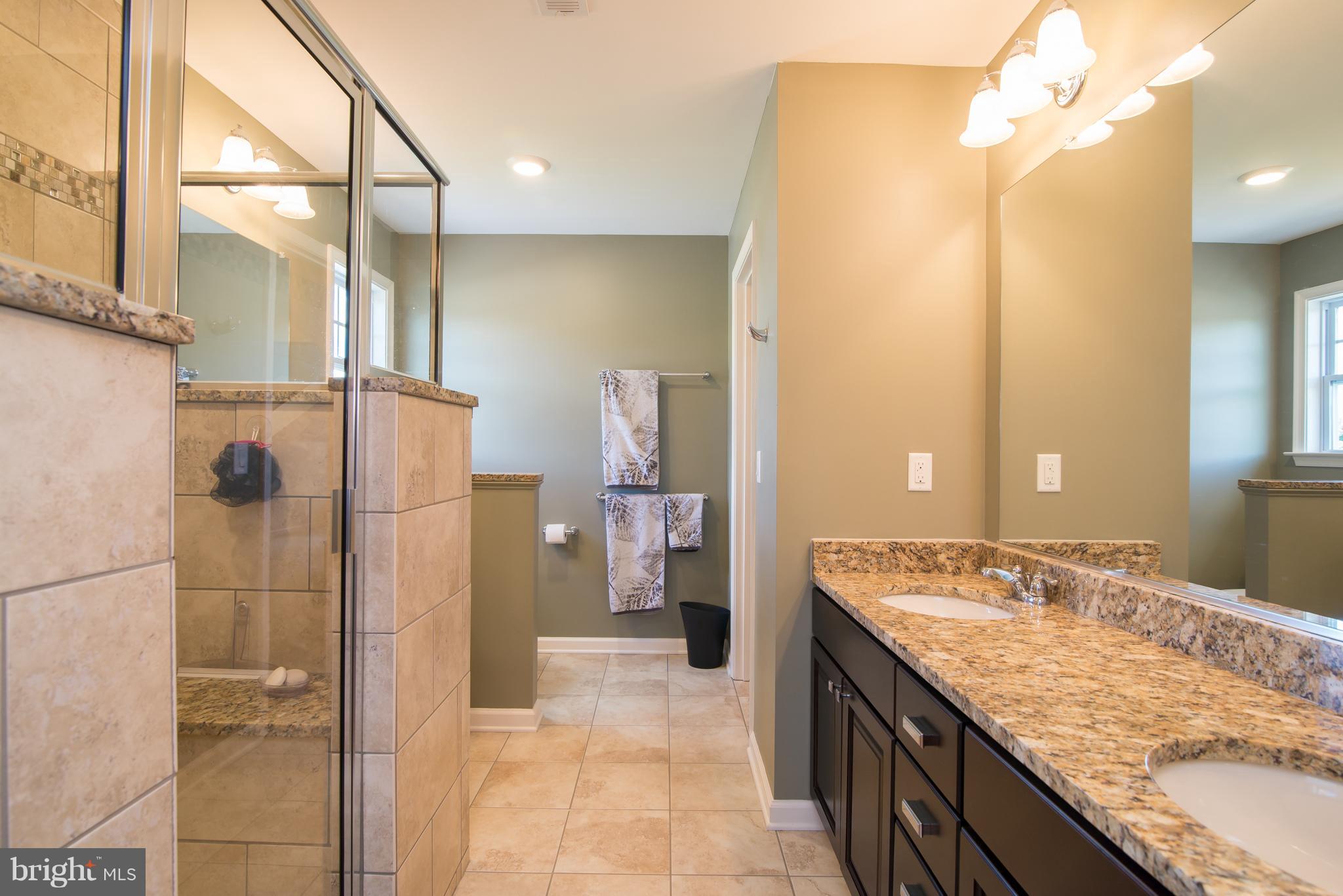 41 Houston Road Inwood, WV 25428 - Photo 22 of 30 a bathroom with a granite countertop sink and a mirror