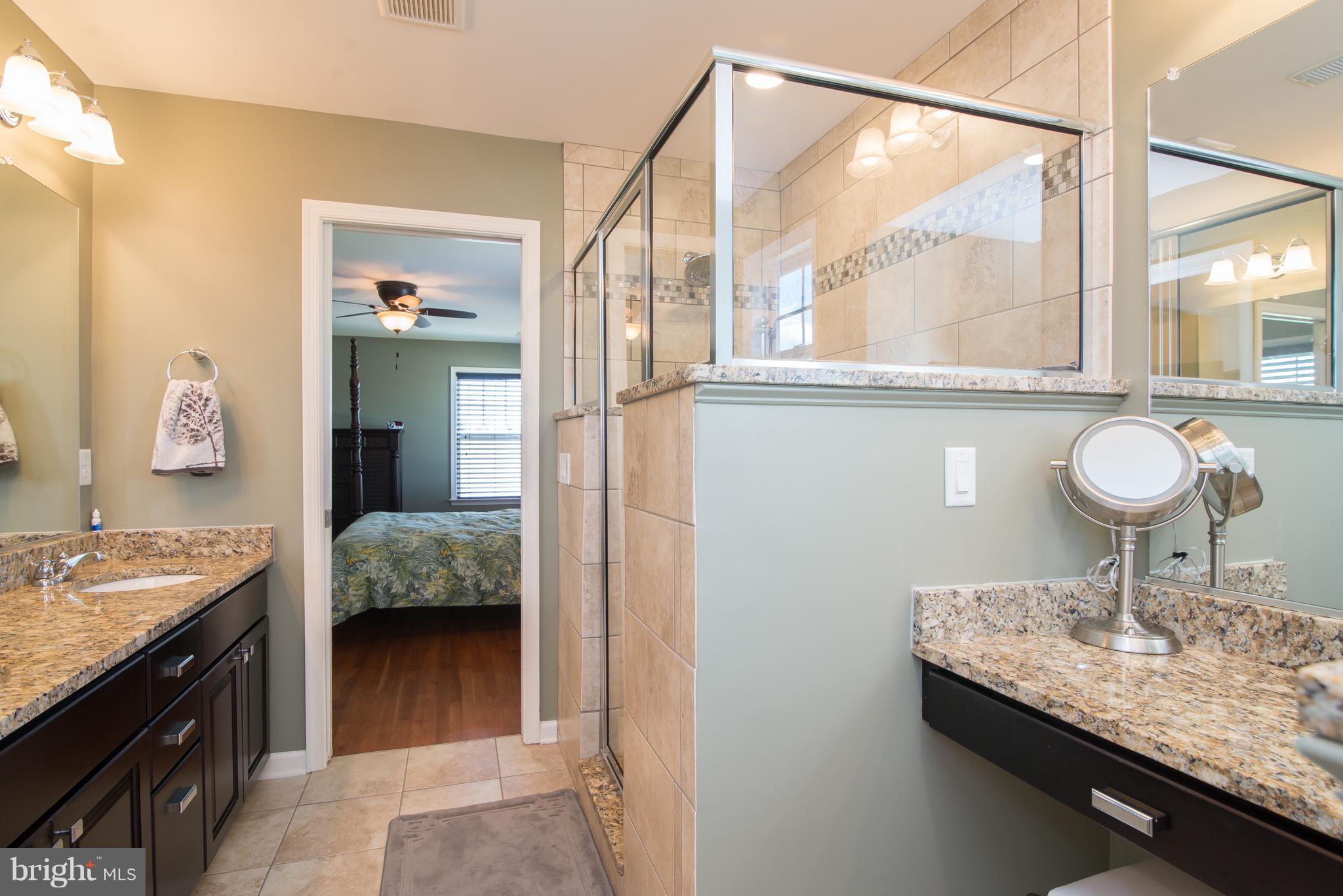41 Houston Road Inwood, WV 25428 - Photo 23 of 30 a en suite bathroom with a granite countertop sink and a mirror