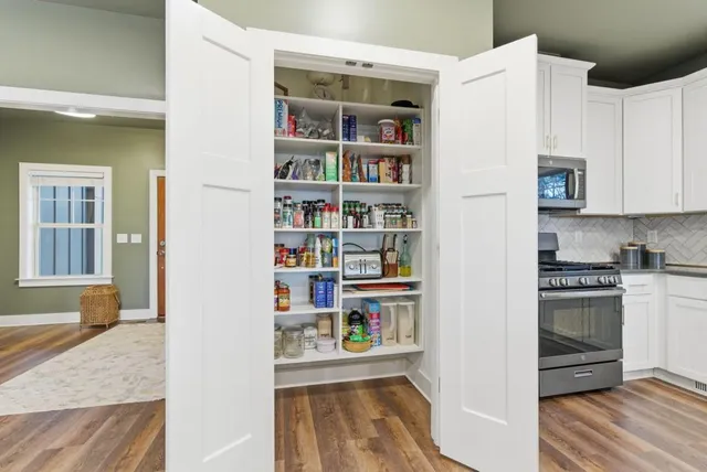 a dining room with furniture a chandelier and wooden floor