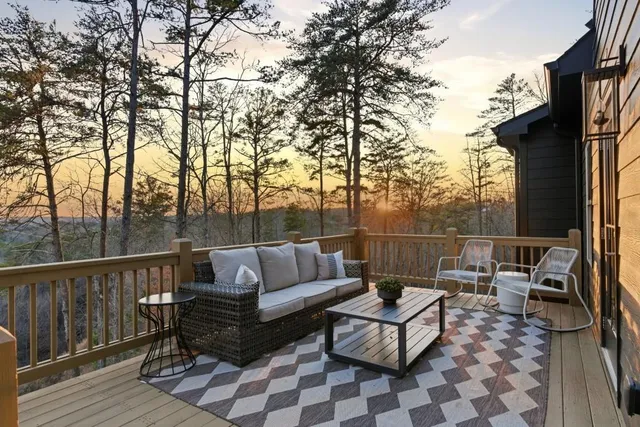 a terrace with outdoor seating and trees