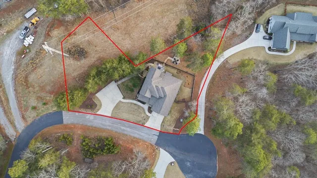 an aerial view of a house with a swimming pool